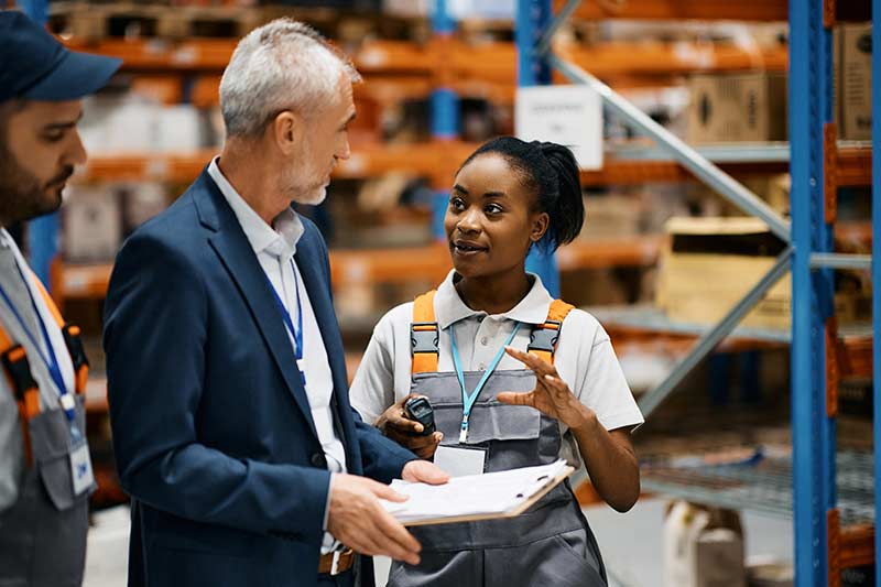 Business owner talking with employees.